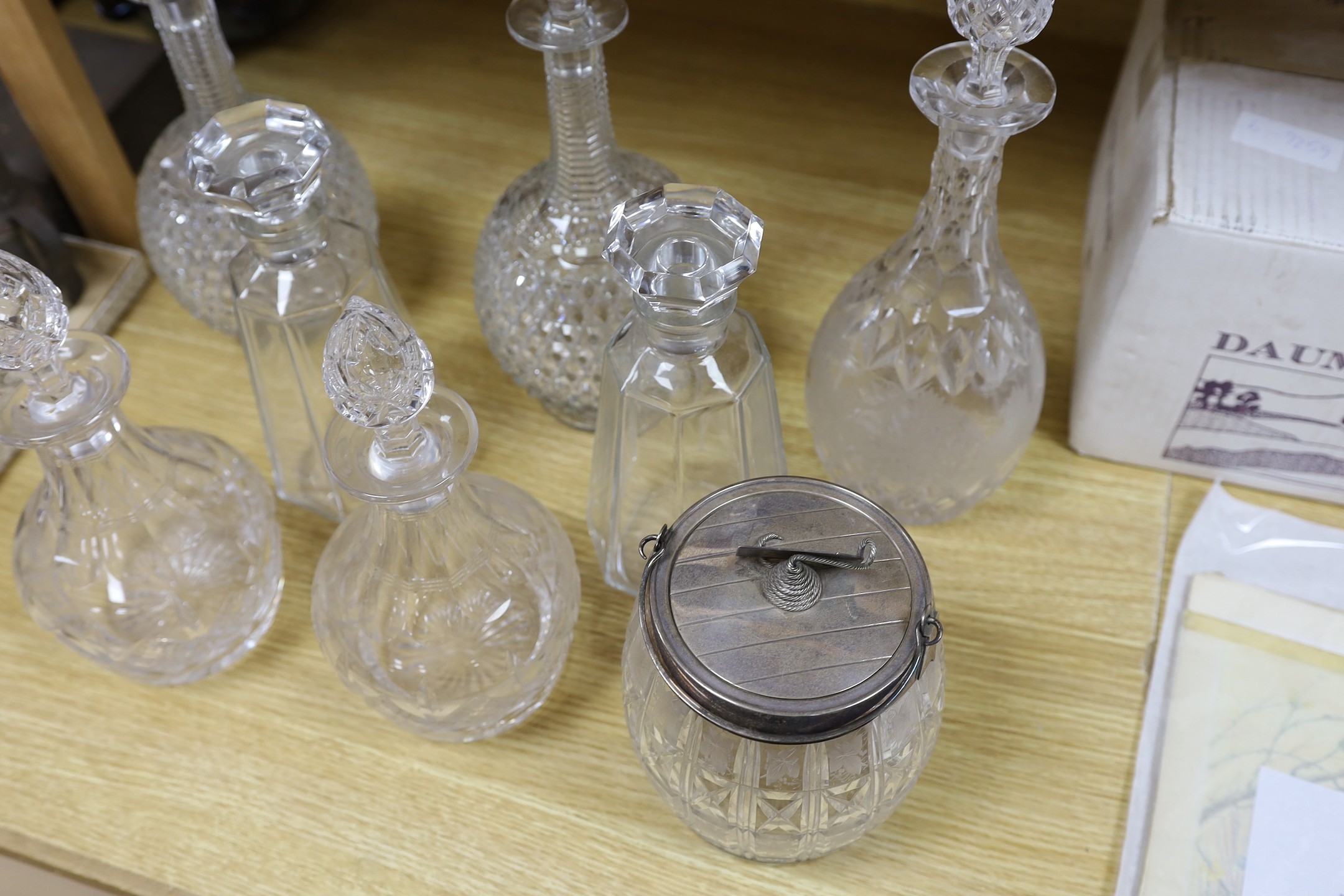 A pair of hobnail cut decanters two other pairs of cut glass decanters a single decanter and a glass and plate biscuit barrel